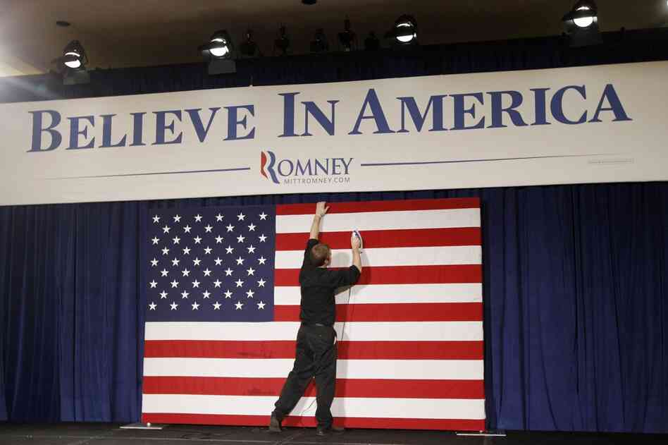 Richie Beanan irons the flag before a rally for Mitt Romney, in Des Moines. 