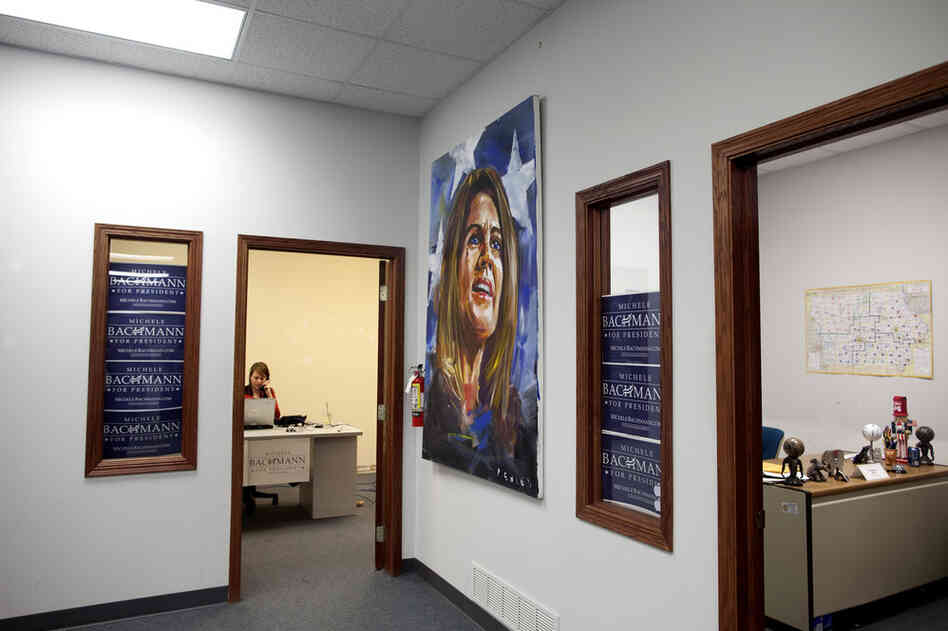 Michele Bachmann's campaign headquarters in the suburbs of Des Moines is located across the street from an empty Herman Cain office.