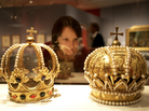 A woman inspects crowns of the Holy Roman Empire at a museum in Berlin. Much like that regime, the Bowl Championship Series is full of ornate pageantry — and also fails to live up to its name, Frank Deford says. A woman inspects crowns of the Holy Roman Empire at a museum in Berlin. Much like that regime, the Bowl Championship Series is full of ornate pageantry — and also fails to live up to its name, Frank Deford says.