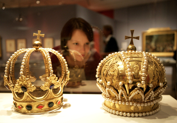 A woman inspects crowns of the Holy Roman Empire at a museum in Berlin. Much like that regime, the Bowl Championship Series is full of ornate pageantry — and also fails to live up to its name, Frank Deford says.