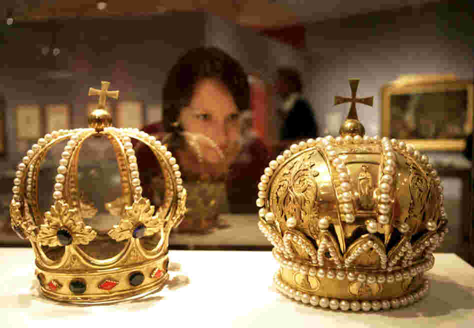 A woman inspects crowns of the Holy Roman Empire at a museum in Berlin. Much like that regime, the Bowl Championship Series is full of ornate pageantry — and also fails to live up to its name, Frank Deford says.