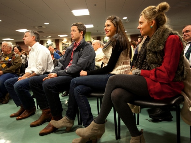 Huntsman (at left in white shirt) listened to an introduction by his wife, Mary Kaye, before speaking in Dover, N.H. Monday night. On the right are his son-in-law, Jeffrey Livingston, and his daughters Abby and Mary Anne. 