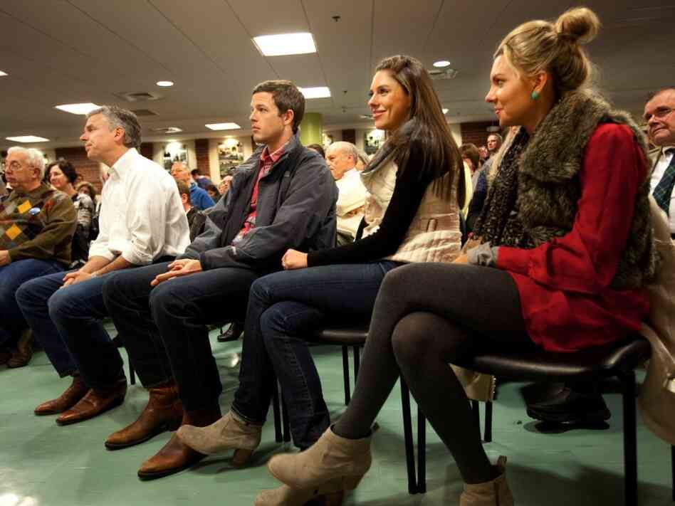 Huntsman (at left in white shirt) listened to an introduction by his wife, Mary Kaye, before speaking in Dover, N.H. Monday night. On the right are his son-in-law, Jeffrey Livingston, and his daughters Abby and Mary Anne. 