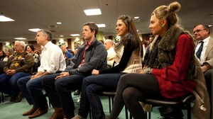 Huntsman (at left in white shirt) listened to an introduction by his wife, Mary Kaye, before speaking in Dover, N.H. Monday night. On the right are his son-in-law, Jeffrey Livingston, and his daughters Abby and Mary Anne.