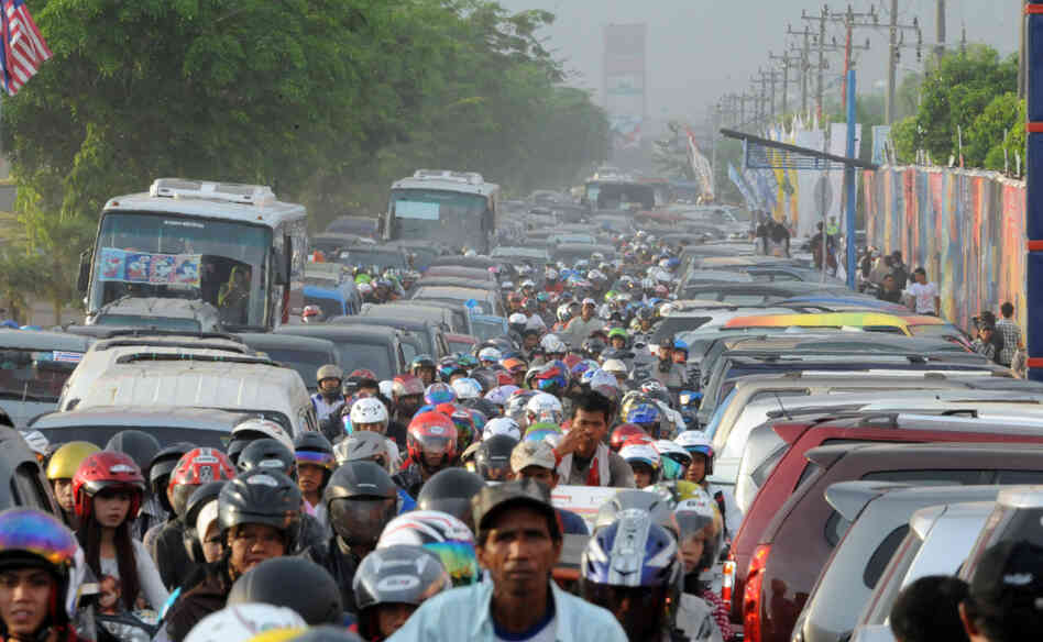 Motorists inch their way in heavy traffic in Palembang, Sumatra, in Indonesia. The nation's rapid growth is overwhelming its weak public infrastructure. Motorists inch their way in heavy traffic in Palembang, Sumatra, in Indonesia. The nation's rapid growth is overwhelming its weak public infrastructure.