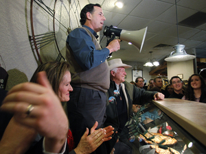 Former Pennsylvania Sen. Rick Santorum, who has recently surged in the Iowa polls, used a bullhorn during a meet-and-greet campaign stop Monday at the Pizza Ranch in Altoona, Iowa. Former Pennsylvania Sen. Rick Santorum, who has recently surged in the Iowa polls, used a bullhorn during a meet-and-greet campaign stop Monday at the Pizza Ranch in Altoona, Iowa.