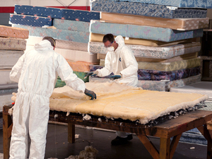 Men dismantle a mattress into reusable parts at the Spring Back recycling project in Nashville, Tenn. Men dismantle a mattress into reusable parts at the Spring Back recycling project in Nashville, Tenn.