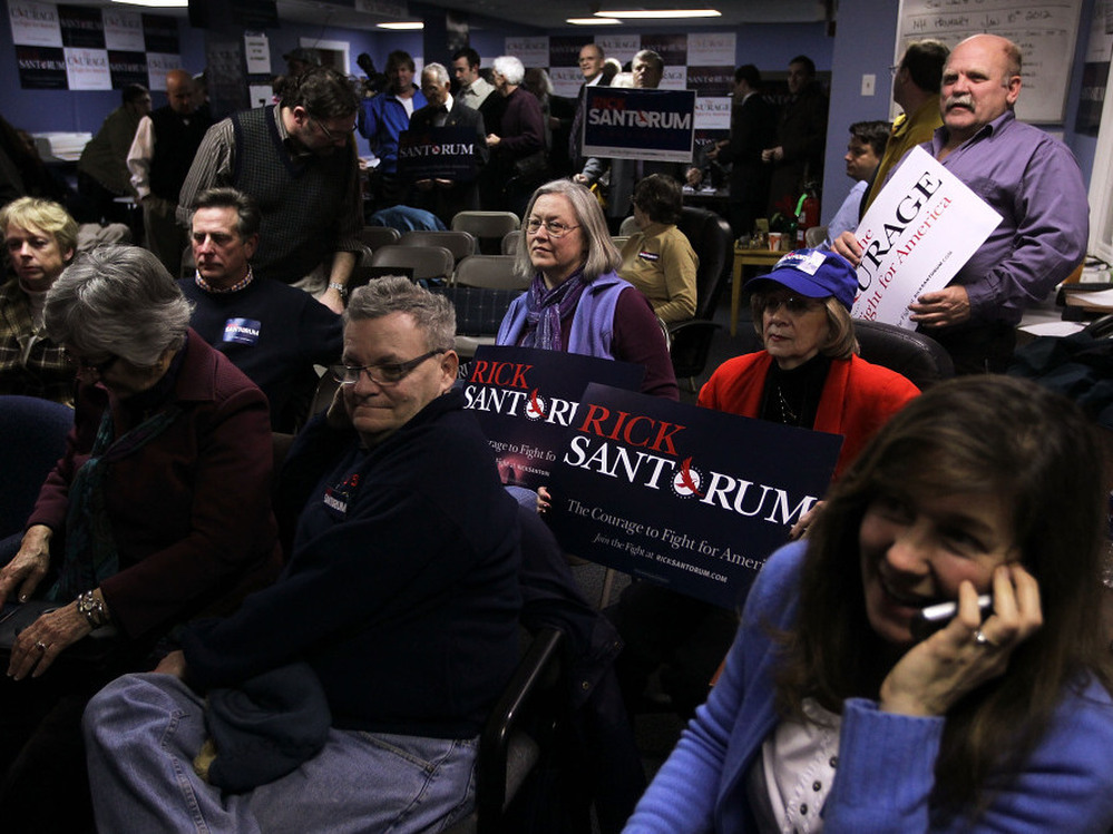 Santorum supporters watch the vote count during an Iowa caucus watch party in New Hampshire on Tuesday night. 