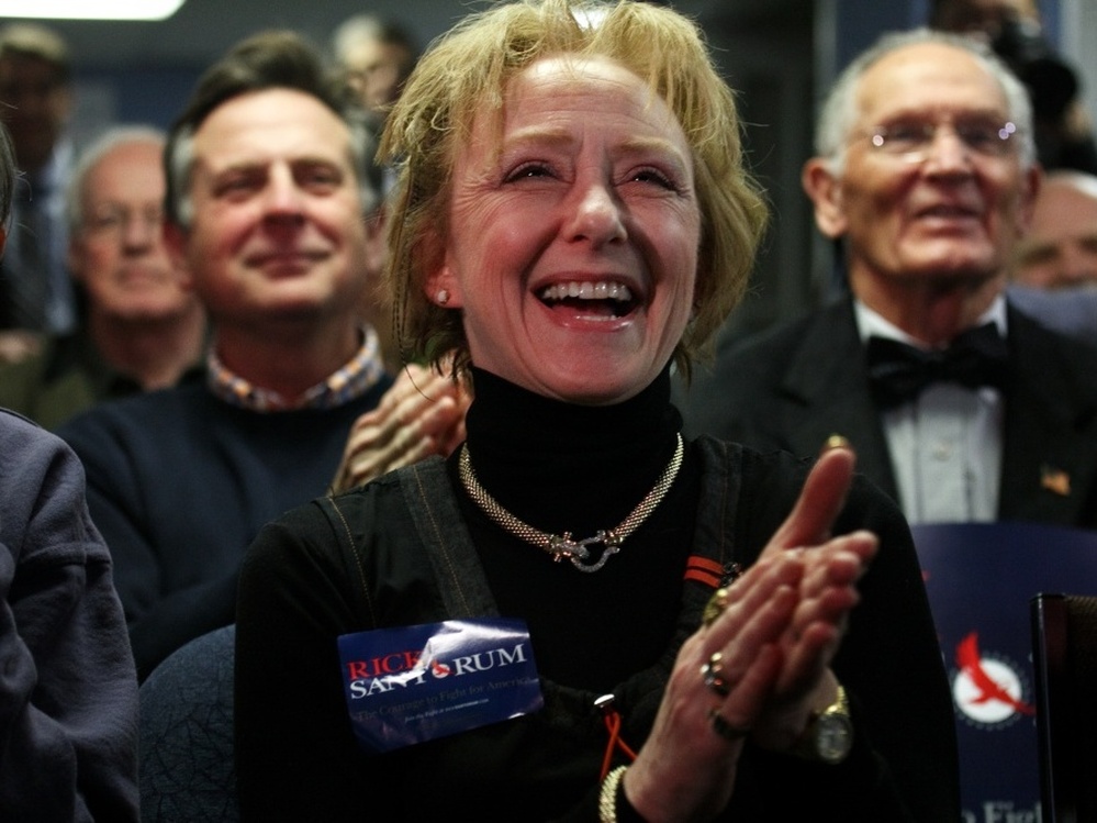 Susan Carroll of Atkinson, N.H., reacts to news of a Santorum lead at a caucus-watching party at Santorum's New Hampshire campaign headquarters in Bedford. Carroll is the Santorum campaign's Tea Party liaison for the state and describes herself as the owner of a small business that offers "artistic services."