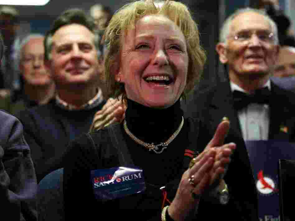 Susan Carroll of Atkinson, N.H., reacts to news of a Santorum lead at a caucus-watching party at Santorum's New Hampshire campaign headquarters in Bedford. Carroll is the Santorum campaign's Tea Party liaison for the state and describes herself as the owner of a small business that offers "artistic services."
