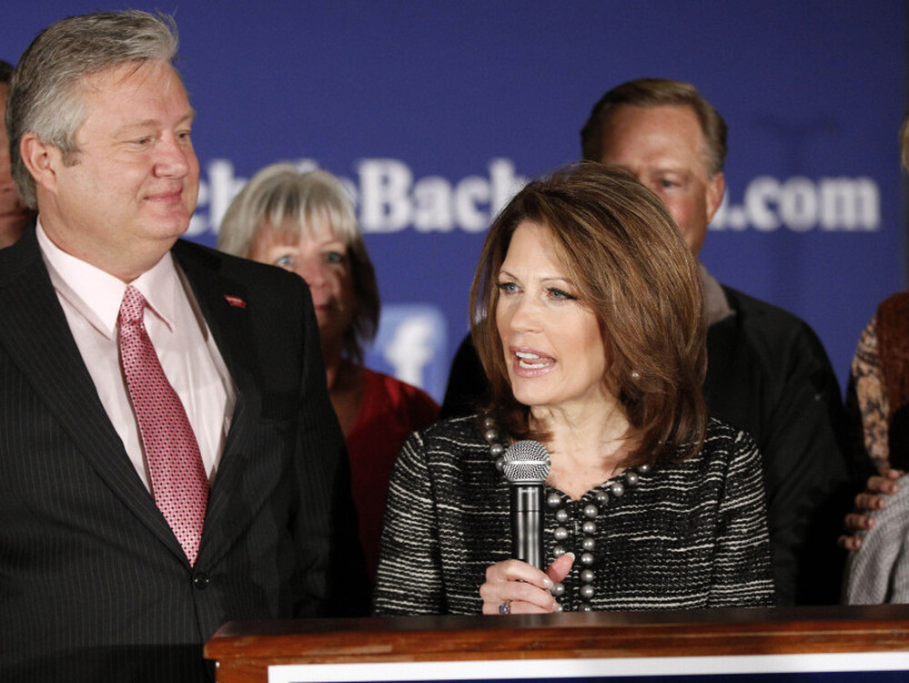 Minnesota Rep. Michele Bachmann, joined by husband Marcus (left) and family and friends, announces that she will end her campaign for president in West Des Moines on Wednesday.