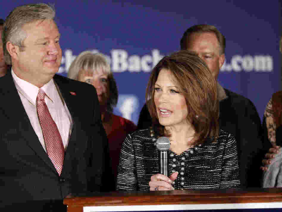 Minnesota Rep. Michele Bachmann, joined by husband Marcus (left) and family and friends, announces that she will end her campaign for president in West Des Moines on Wednesday.
