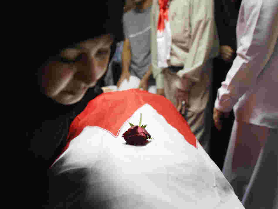 An independent commission found that the Bahrain security forces used excessive force and tortured some of those detained. Here, family members look upon the body of protester Abdul Ridha Mohammed, who was shot in the head and died of his wounds on Feb. 21, 2011.