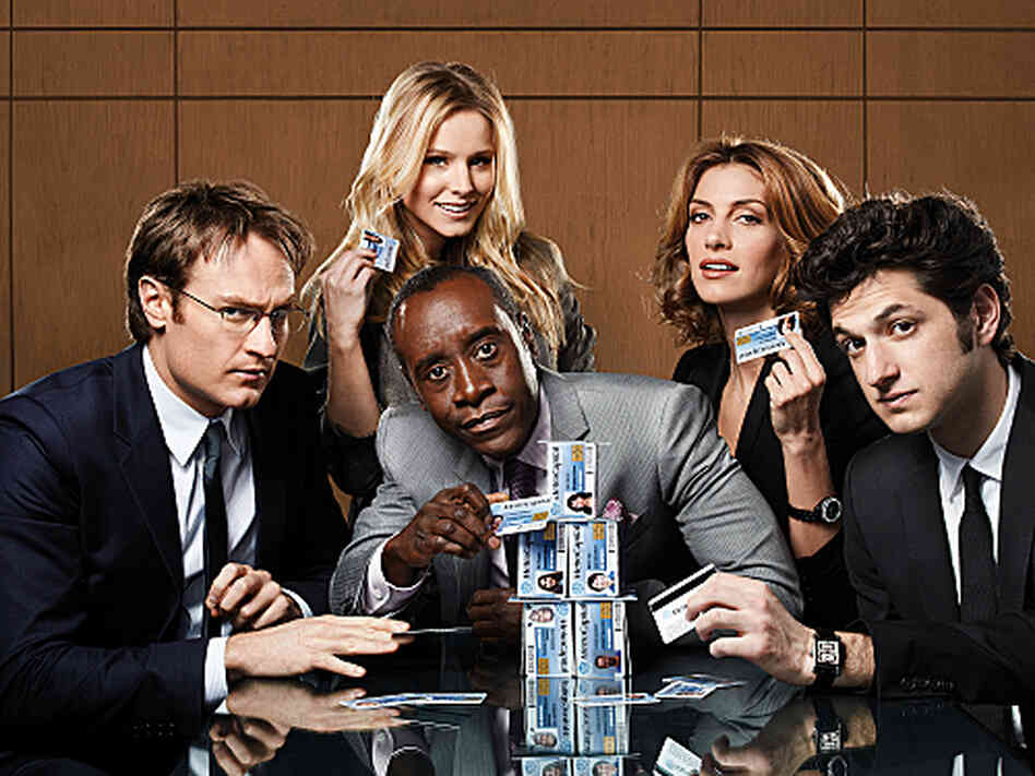 In House of Lies, Don Cheadle and Kristen Bell play management consultants who are willing to do whatever it takes to get a deal finished. In House of Lies, Don Cheadle and Kristen Bell play management consultants who are willing to do whatever it takes to get a deal finished.