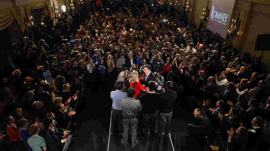 Republican presidential candidate, former Massachusetts Gov. Mitt Romney is the center of attention at rally in Des Moines, Iowa, Tuesday.