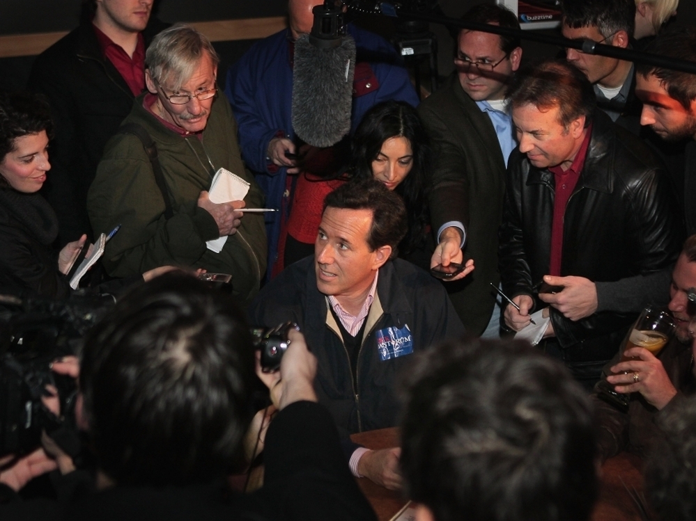 Republican presidential candidate and former U.S. Senator Rick Santorum is mobbed by press on Dec. 30 in Ames, Iowa. 