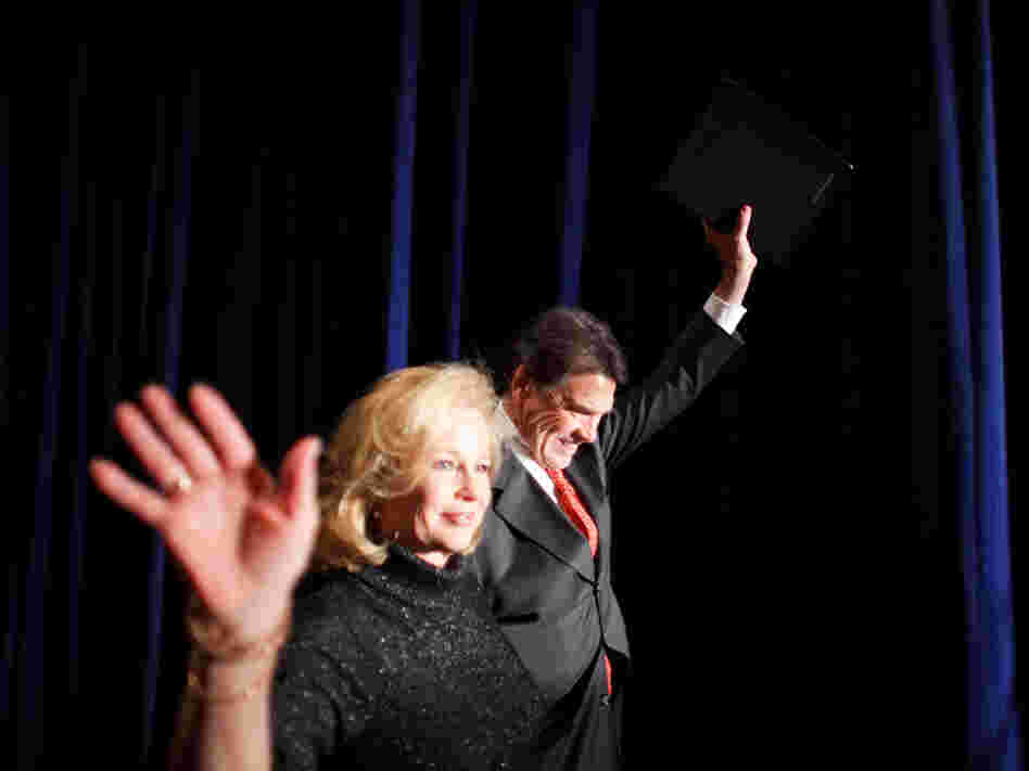 Texas Gov. Rick Perry and his wife, Anita, greet supporters after the Iowa caucuses.