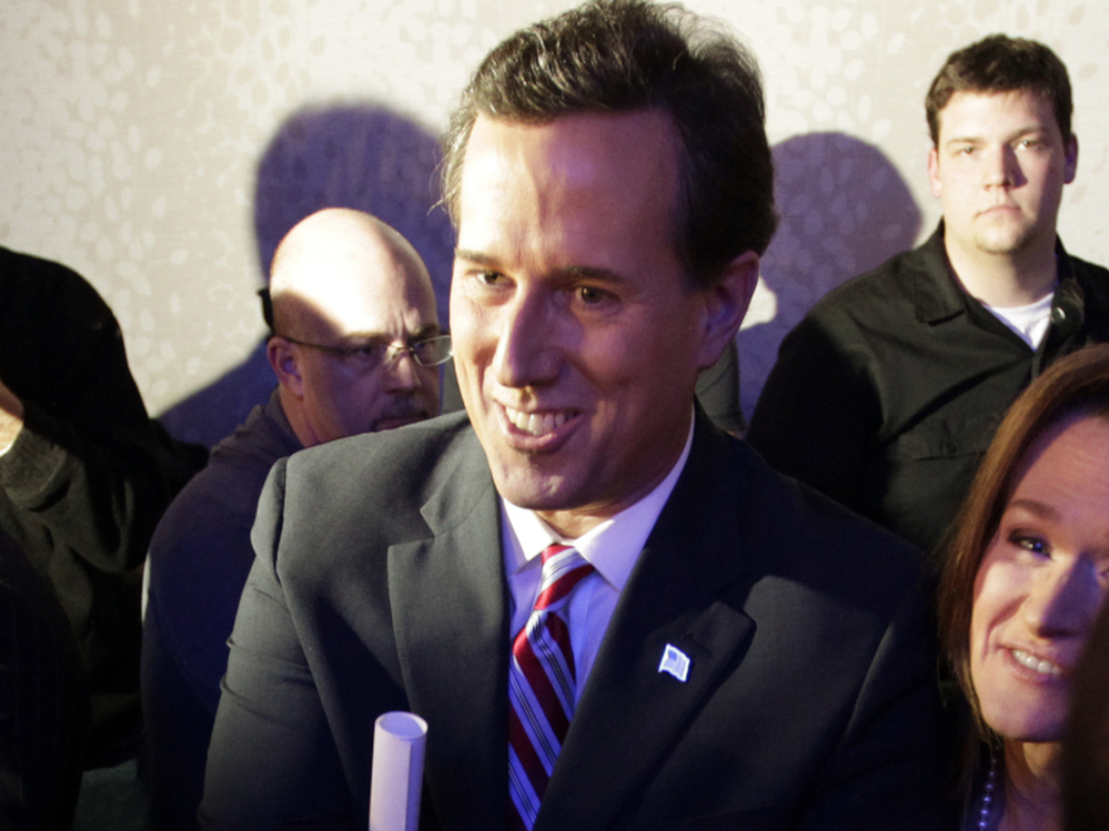 Former Pennsylvania Sen. Rick Santorum greets supporters after his caucus night rally in Johnston, Iowa, on Tuesday.