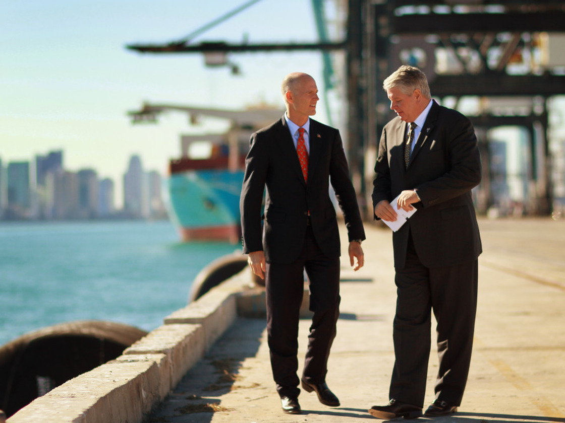Port of Miami Director Bill Johnson (right) speaks to Florida Gov. Rick Scott at the port. "It is the game changer," Johnson says of the city's plan to deepen its port to accept new, larger ships from the Panama Canal.