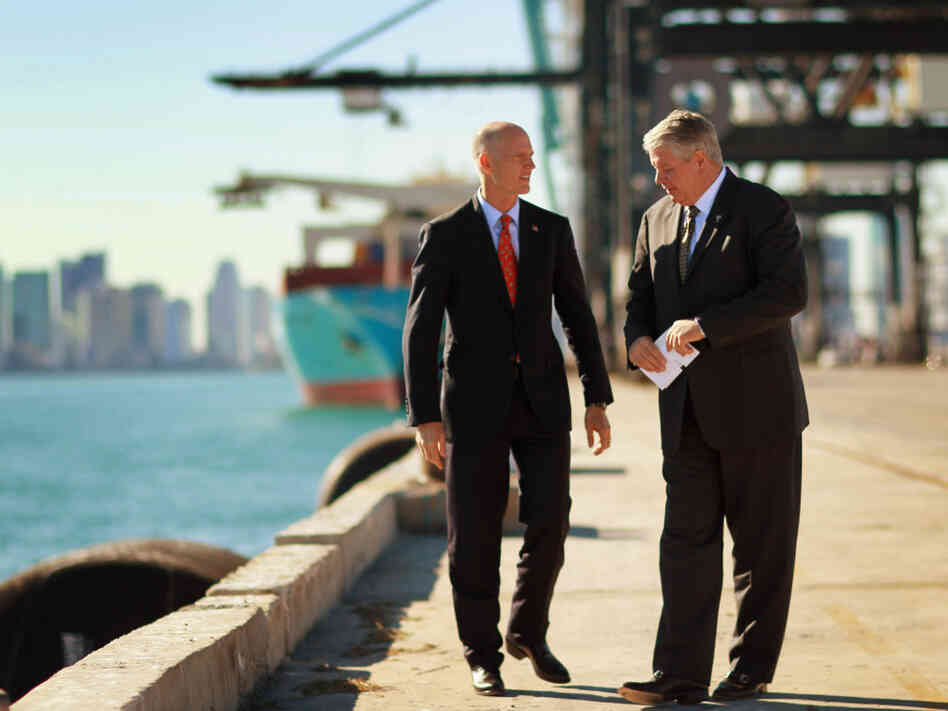 Port of Miami Director Bill Johnson (right) speaks to Florida Gov. Rick Scott at the port. "It is the game changer," Johnson says of the city's plan to deepen its port to accept new, larger ships from the Panama Canal.