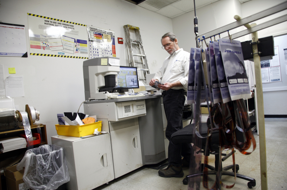 Bill Jonscher works behind the scenes at Penn Camera, processing film and making prints.