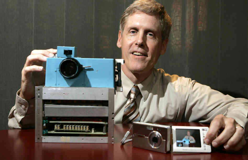 Steven J. Sasson shows the world's first digital camera (left), which he built in 1975, next to Kodak's EasyShare One, at Kodak headquarters in Rochester, N.Y., in 2005. The company is now trying to sell about a thousand patents for digital photography to prevent bankruptcy. Steven J. Sasson shows the world's first digital camera (left), which he built in 1975, next to Kodak's EasyShare One, at Kodak headquarters in Rochester, N.Y., in 2005. The company is now trying to sell about a thousand patents for digital photography to prevent bankruptcy.