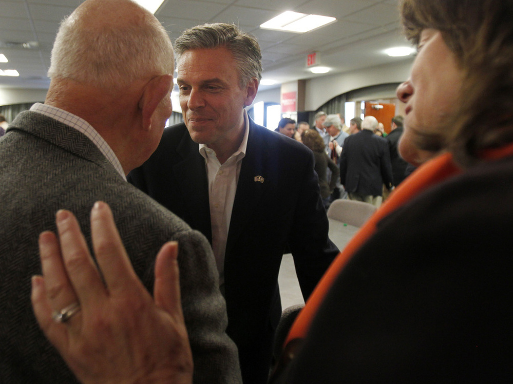 Former Utah Gov. Jon Huntsman shakes hands with voters following a business lunch campaign event in Portsmouth, N.H. on Jan. 5. 