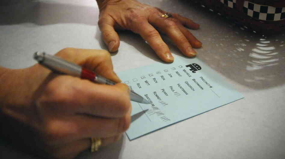 Barb Hansen tallies votes during a GOP caucus in precinct 42 near Smithland, Iowa, on Tuesday, Jan. 3, 2012.