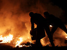 Two men try to extinguish a tire fire Thursday in Sitra, Bahrain, near the site of an opposition rally.Nightly clashes between riot police and protesters continued Thursday night nationwide. Two men try to extinguish a tire fire Thursday in Sitra, Bahrain, near the site of an opposition rally.Nightly clashes between riot police and protesters continued Thursday night nationwide.