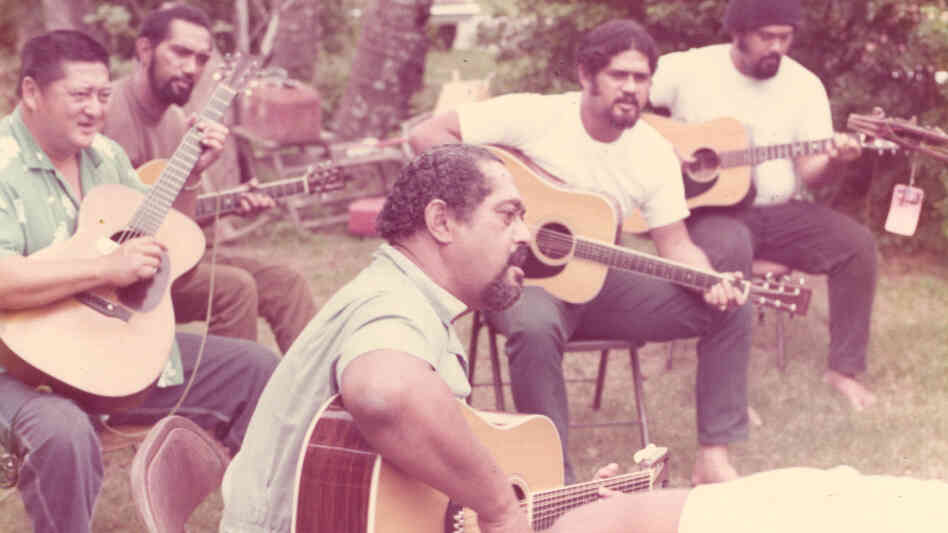 Gabby Pahinui (center), playing in his family's backyard with (from left to right) Leland "Atta" Isaacs, Philip Pahinui, Cyril Pahinui and Martin Pahinui. This photo is in the album insert for the 1972's Gabby. Gabby Pahinui (center), playing in his family's backyard with (from left to right) Leland "Atta" Isaacs, Philip Pahinui, Cyril Pahinui and Martin Pahinui. This photo is in the album insert for the 1972's Gabby.