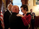 Captain Mark Kelly hugs his wife, Rep. Gabrielle Giffords (D-Ariz.) at the White House in October. Captain Mark Kelly hugs his wife, Rep. Gabrielle Giffords (D-Ariz.) at the White House in October.