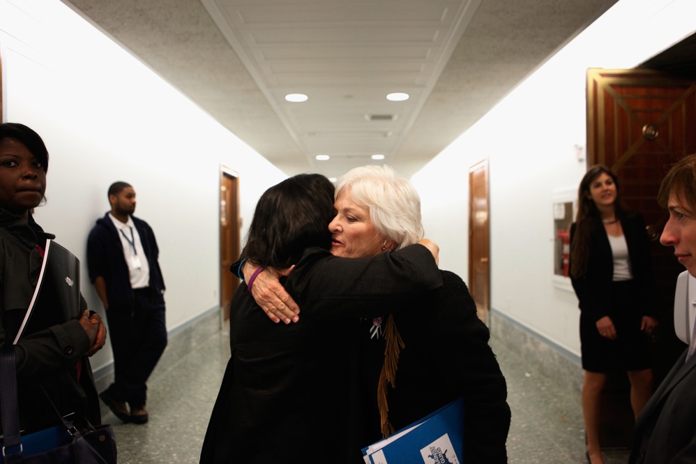 Patricia Maisch (right), who helped disarm Loughner, embraces Georgia Lerner, whose mother died in the shooting. Maisch testified on Capitol Hill in support of a bill to strengthen background checks for people who buy firearms. 