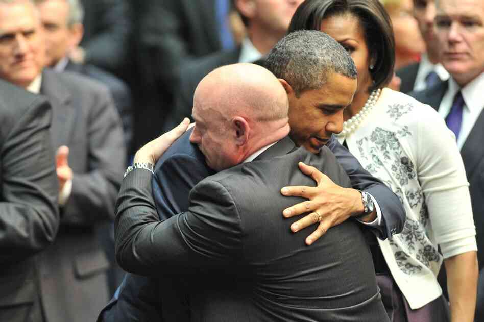 President Obama hugs Kelly during a memorial service, "Together We Thrive: Tucson and America," at the McKale Memorial Center in Tucson on Jan. 12. 
