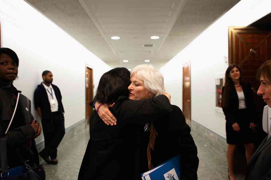 Patricia Maisch (right), who helped disarm Loughner, embraces Georgia Lerner, whose mother died in the shooting. Maisch testified on Capitol Hill in support of a bill to strengthen background checks for people who buy firearms. 