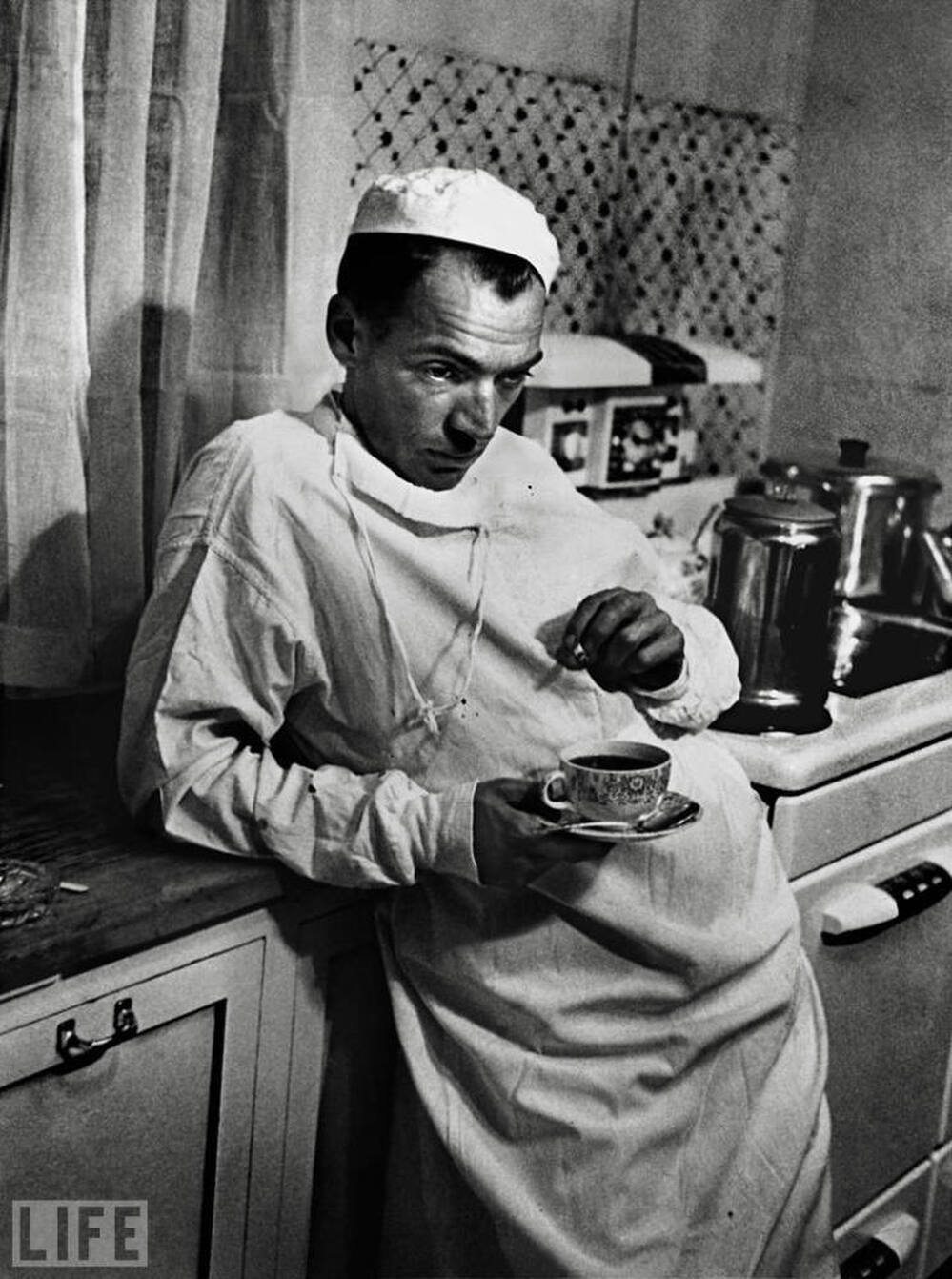 Dr. Ernest Ceriani, the subject of a 1948 Life magazine story titled "Country Doctor," pauses after a long surgery.