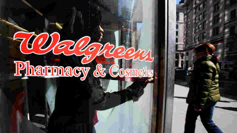 A customer walks out of a Walgreens store in New York City. A customer walks out of a Walgreens store in New York City.