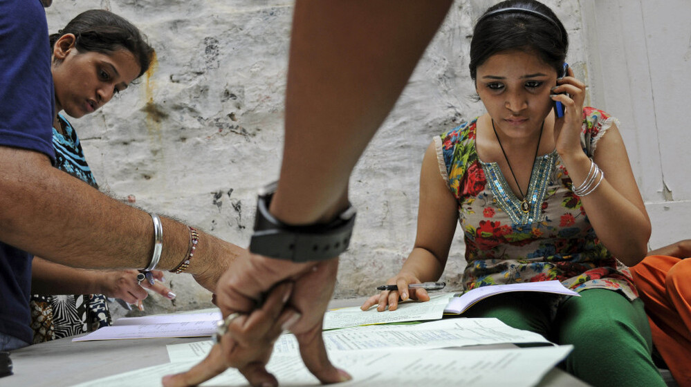 Competition for admission to India's top school, Delhi University, is particularly fierce. Here students fill out forms at the Arts Faculty in New Delhi, India, on June 21.