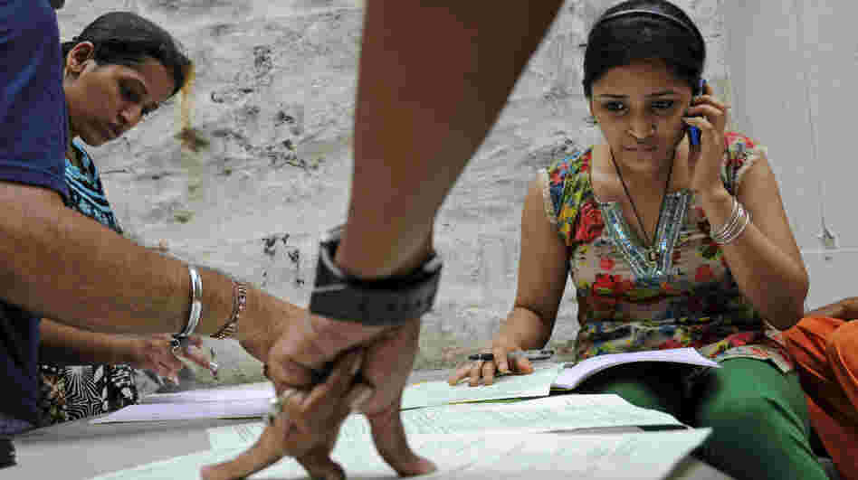 Competition for admission to India's top school, Delhi University, is particularly fierce. Here students fill out forms at the Arts Faculty in New Delhi, India, on June 21.