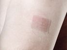 An older man wears a nicotine patch on his left arm. An older man wears a nicotine patch on his left arm.