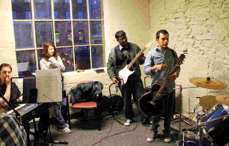 Music educator Ivan Trevino (right) leads band practice for M5 Networks employees in Rochester, N.Y., who will play against other branches in a battle of the bands. The telecom company says it wants its employees to learn new things (and stay happy). Music educator Ivan Trevino (right) leads band practice for M5 Networks employees in Rochester, N.Y., who will play against other branches in a battle of the bands. The telecom company says it wants its employees to learn new things (and stay happy).