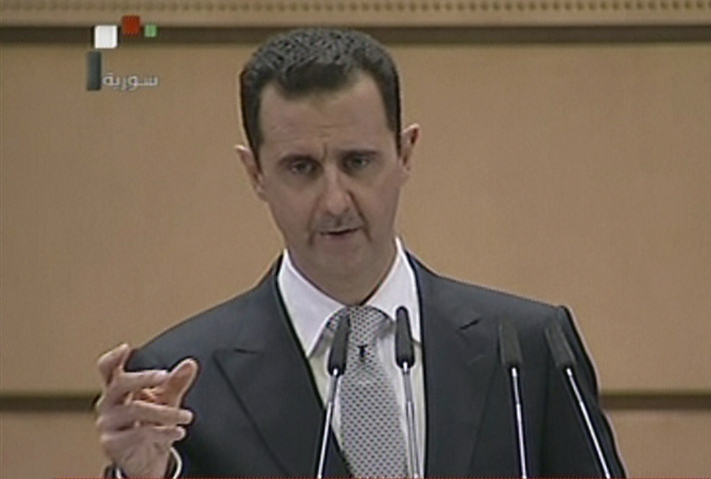 An image from Syrian state television shows Syrian President Bashar Assad delivering his speech Tuesday in Damascus.