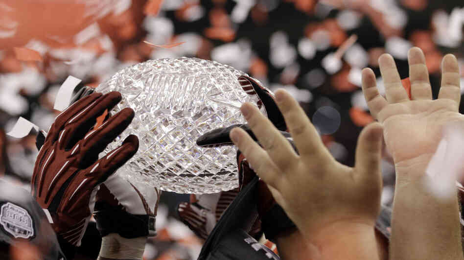 Alabama players celebrates with their trophy after the BCS National Championship college football game against LSU on Monday.