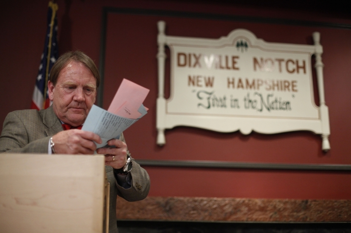 Tom Tillotson removes ballots for counting after midnight Tuesday in Dixville Notch, N.H.