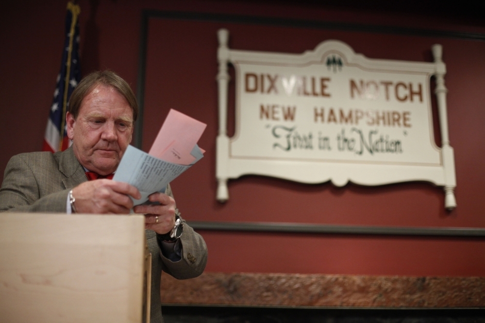 Tom Tillotson removes ballots for counting after midnight Tuesday in Dixville Notch, N.H.