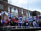 Supporters for various candidates hold signs at the Webster School polling location in Manchester, N.H., on Tuesday. Supporters for various candidates hold signs at the Webster School polling location in Manchester, N.H., on Tuesday.