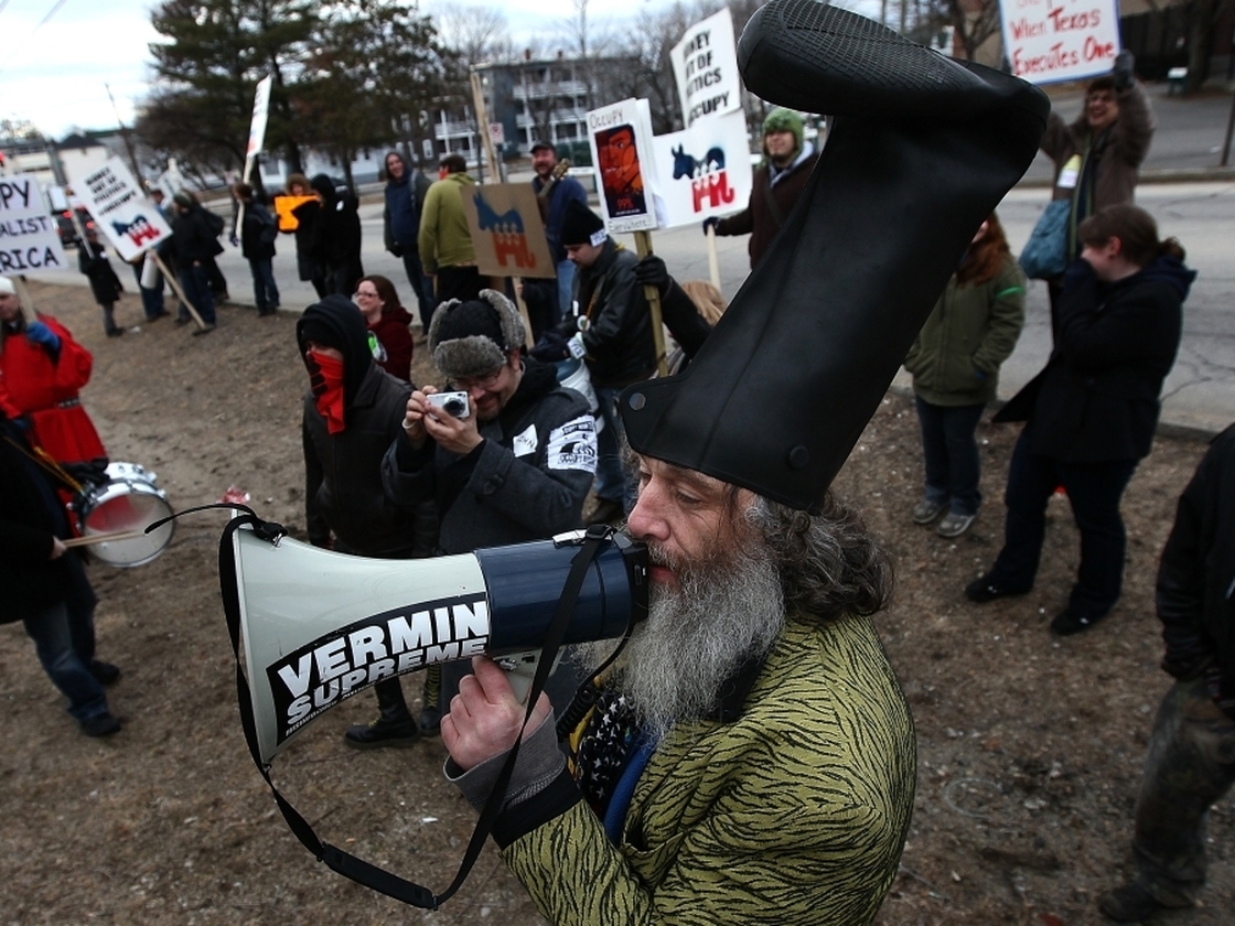 Fringe candidate Vermin Supreme demonstrates with Occupy protesters on Sunday, outside a restaurant where Republican presidential candidate Newt Gingrich held a town hall meeting in New Hampshire.