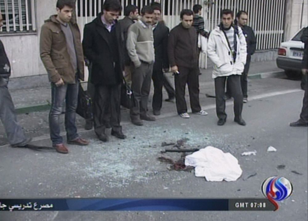 An image grab taken from footage broadcast by Iran's state-run Arabic-language Al-Alam TV shows blood stains covered by a piece of cloth and debris at the site of the car bomb.