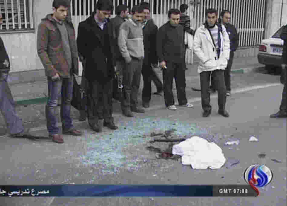 An image grab taken from footage broadcast by Iran's state-run Arabic-language Al-Alam TV shows blood stains covered by a piece of cloth and debris at the site of the car bomb.