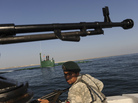 A member of Iran's navy participates in a drill on Dec. 28, 2011, in the Sea of Oman. Tehran is threatening to close the strategic Strait of Hormuz at the mouth of the Persian Gulf, in retaliation for new sanctions by the West. A member of Iran's navy participates in a drill on Dec. 28, 2011, in the Sea of Oman. Tehran is threatening to close the strategic Strait of Hormuz at the mouth of the Persian Gulf, in retaliation for new sanctions by the West.