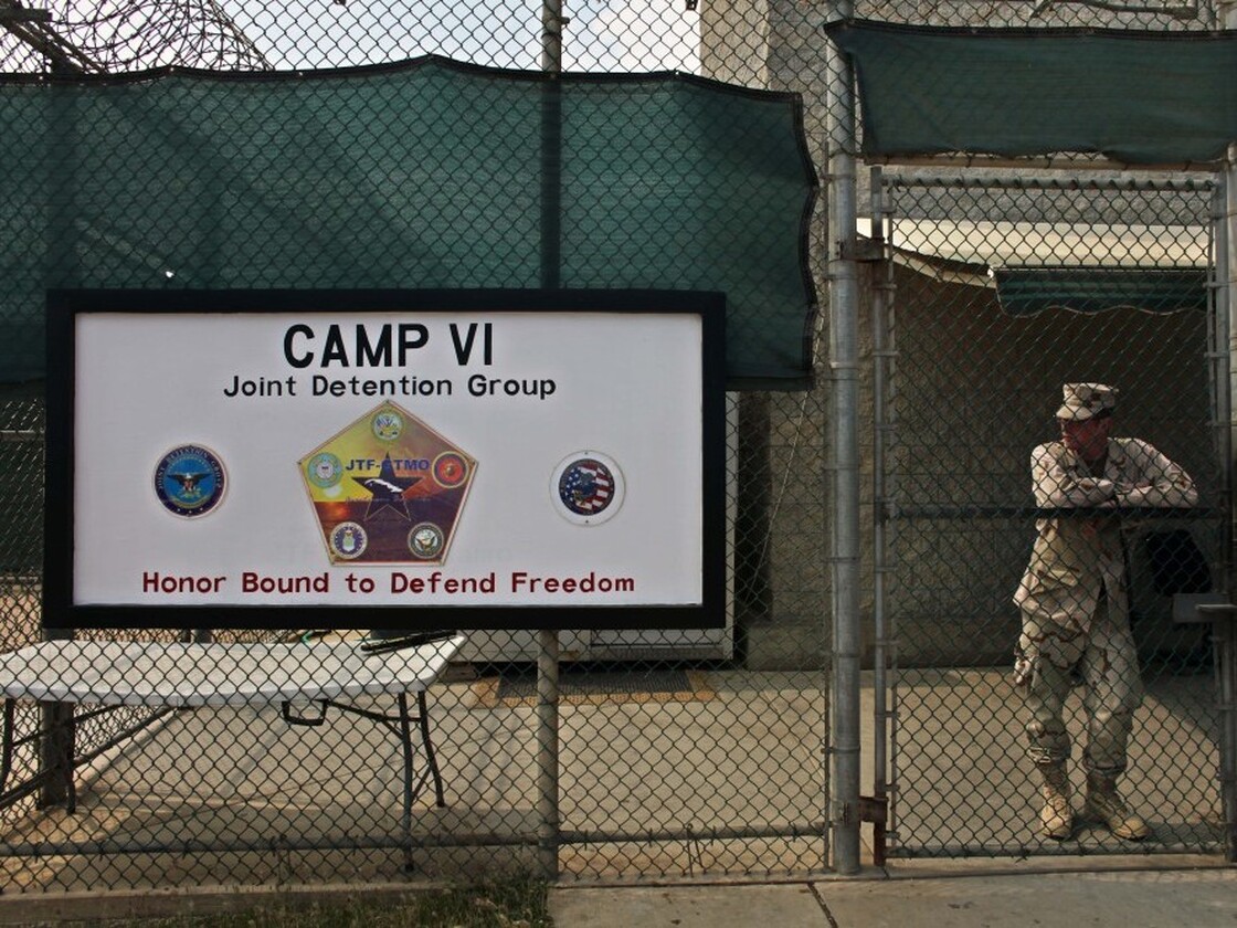 A soldier stands guard at the front gate to Guantanamo's Camp 6 maximum-security detention facility in 2009. Wednesday marks 10 years since detainees first arrived at the detention facility.